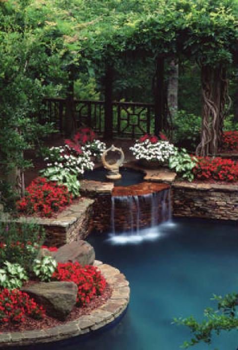 Traditional Pool with stone brick raised flower beds