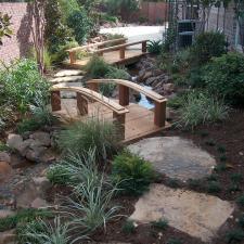 Transitional Landscape with tall red brick privacy wall