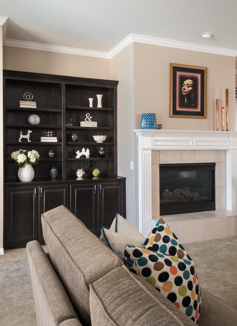 Eclectic Family Room with stained dark brown built in cabinets