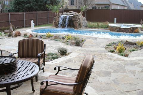 Traditional Pool with wrought iron outdoor furniture