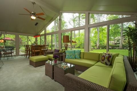 Contemporary Sunroom with green cushions