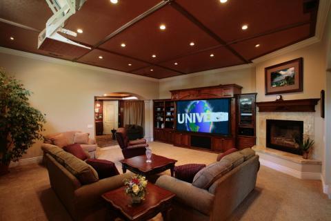 Contemporary Home Theater with marble tile fireplace surround