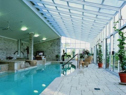 Contemporary Sunroom with hot tub with stone surround