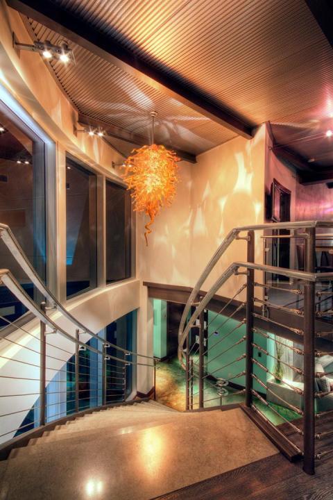 Contemporary Entry with large abstract orange glass chandelier
