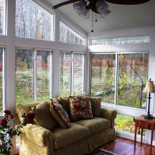 Contemporary Sunroom with red wood stained floor