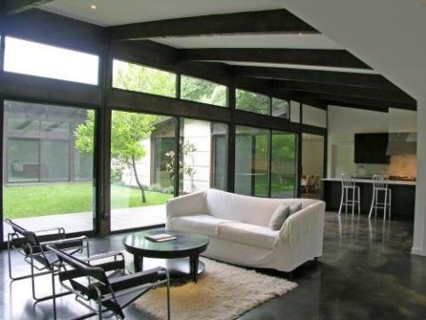 Contemporary Family Room with black painted cement floors