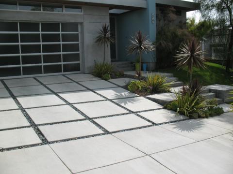 Modern Garage with black pebble stone driveway trim border