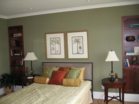 Tropical Bedroom with dark wood light gray upholstered headboard