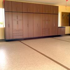 Transitional Garage with wall hung cabinetry