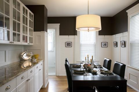 Transitional Dining Room with white wood wall paneling back splash