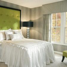 Contemporary Bedroom with bright green upholstered head board