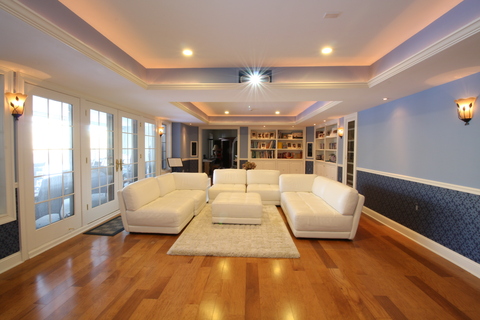 Contemporary Home Theater with built in white bookshelves
