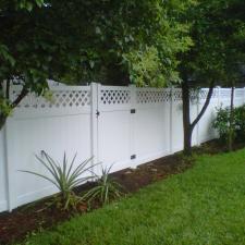 Transitional Landscape with flower garden lining fence