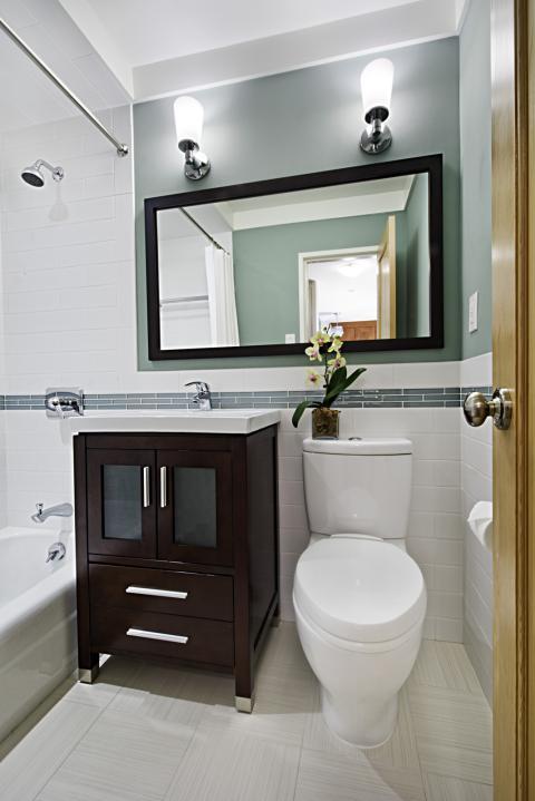 Contemporary Bathroom with dark brown bathroom vanity with white porcelain counter top