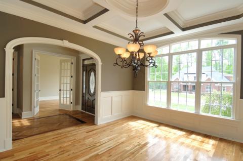 Transitional Dining Room with dark wood front door with detailed glass panel