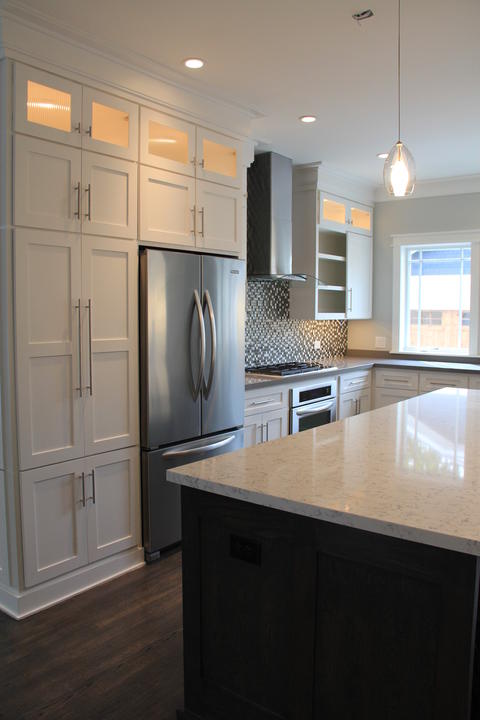 Transitional Kitchen with glass display cabinet doors