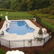 Contemporary Pool with wrought iron fence