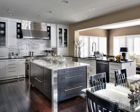Contemporary Kitchen with kitchen island with silver accents and white marble counter tops