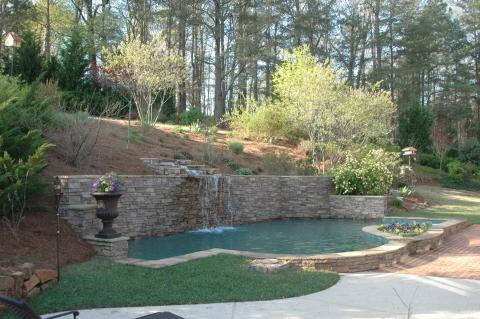 Traditional Pool with stone retaining walls