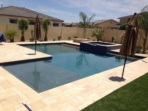 Contemporary Pool with tiled pool surround