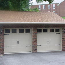 Transitional Garage with rain gutter and downspout