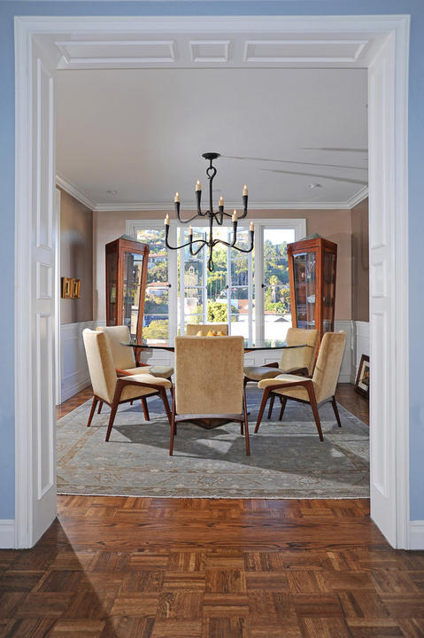 Transitional Dining Room with blue patterned area rug carpet