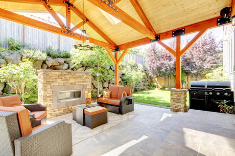 Rustic Patio with outdoor stone stacked freestanding fireplace