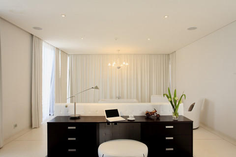 Contemporary Home Office with white upholstered ottoamn