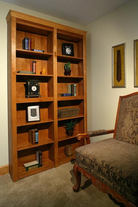 Transitional Home Office with medium wood stained book case