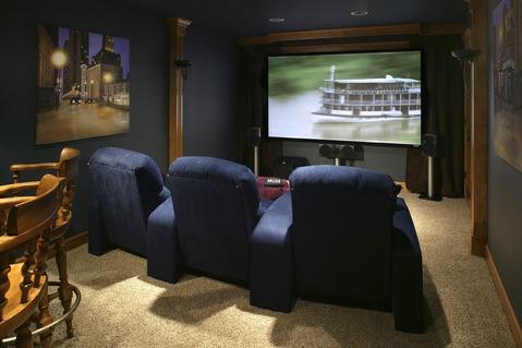 Traditional Home Theater with navy movie theater chairs