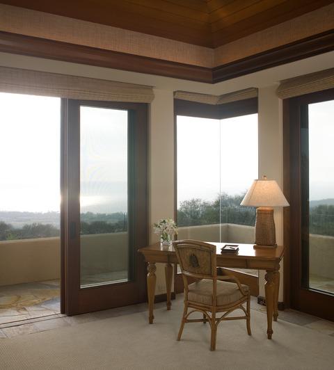 Contemporary Bedroom with tan roman style shade window coverings