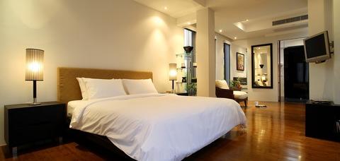 Contemporary Bedroom with dark wood framed body mirror mounted to wall
