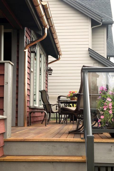 Contemporary Deck with copper downspouts