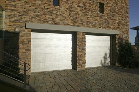 Transitional Garage with dark gray stone brick driveway
