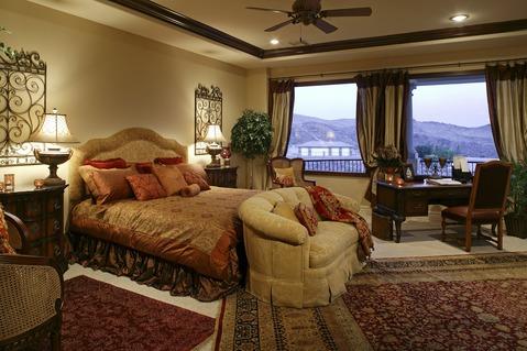 Traditional Bedroom with large deep red floral area rugs