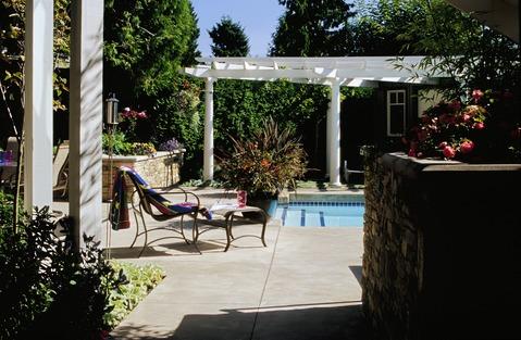Traditional Home Exterior with white trellis over pool