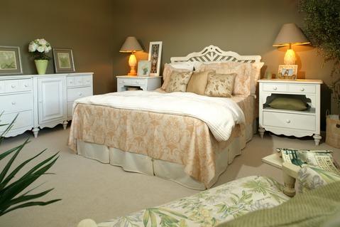 Traditional Bedroom with orange and white bedding