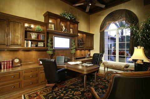 Traditional Home Office with medium wood stained cabinets