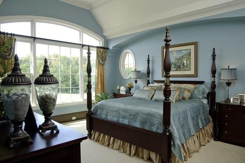 Traditional Bedroom with gold and blue window curtains