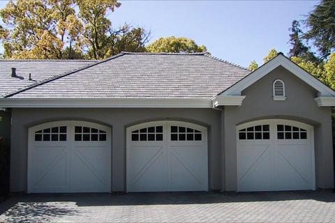 Transitional Garage with carriage style garage doors