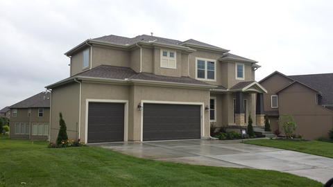 Transitional Home Exterior with brown raised panel garage door