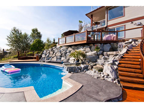Contemporary Pool with stamped concrete pool surround