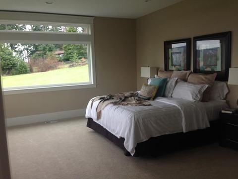 Transitional Bedroom with tan wall to wall carpet
