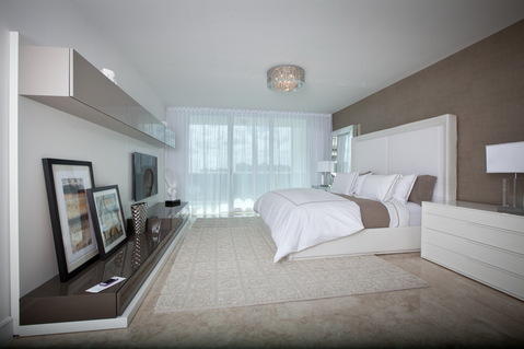Contemporary Bedroom with sliding glass door to balcony