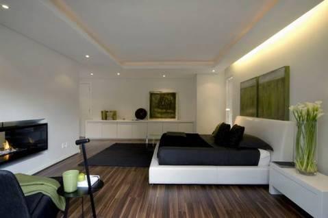 Contemporary Bedroom with wall mounted glass fireplace