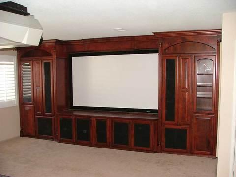 Traditional Home Theater with dark raised panel cabinets