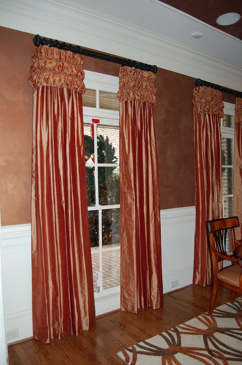 Contemporary Dining Room with deep orange floor length curtains