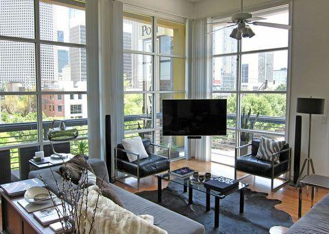 Contemporary Family Room with metal framed glass top coffee table