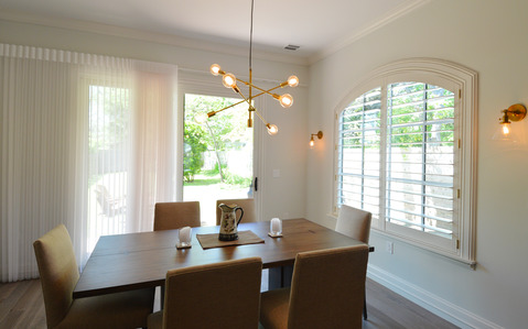 Modern Dining Room with wood shutters window covering