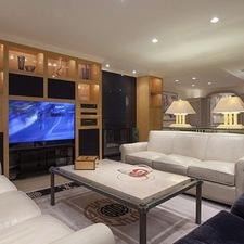 Eclectic Family Room with light wood built in entertainment center